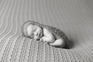 alt="black and white newborn picture on blanket"