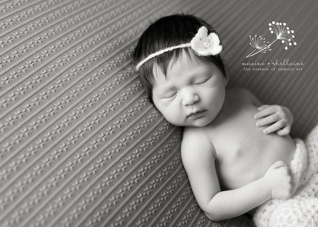 alt=black and white newborn sleeping image
