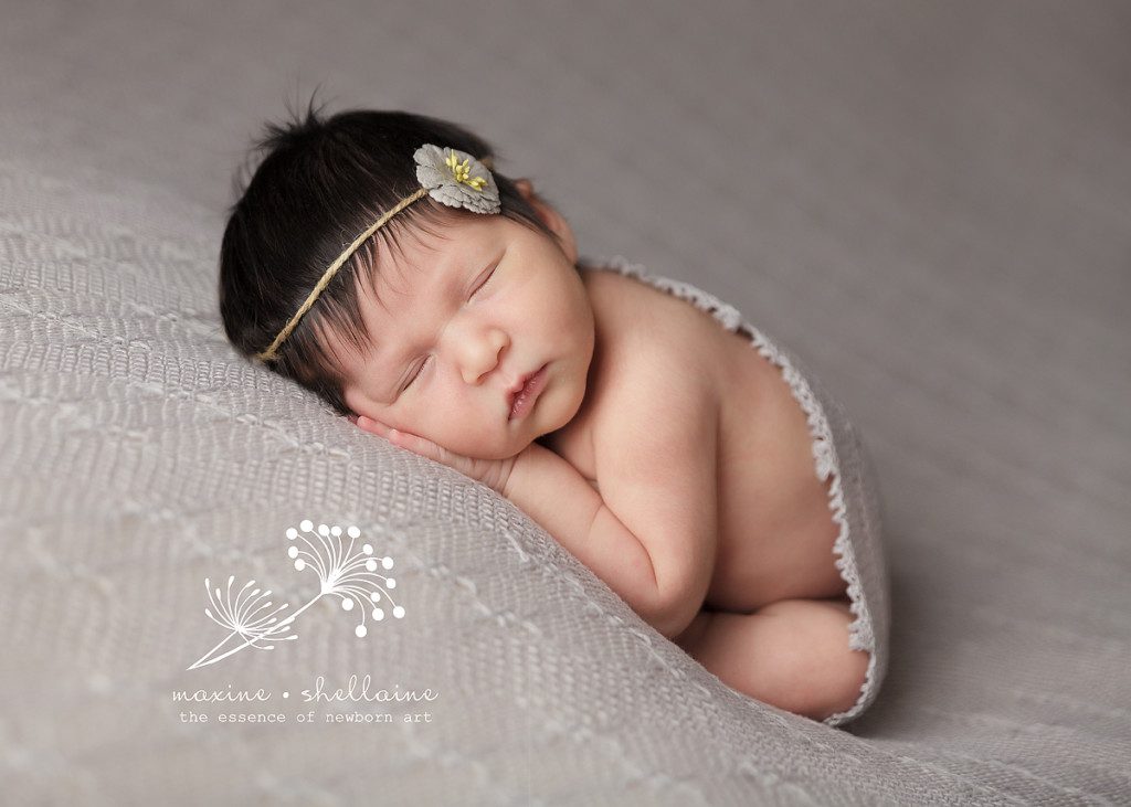 alt=baby sleeping on grey blanket, alt=taco pose, alt=baby girl wearing grey flower headband