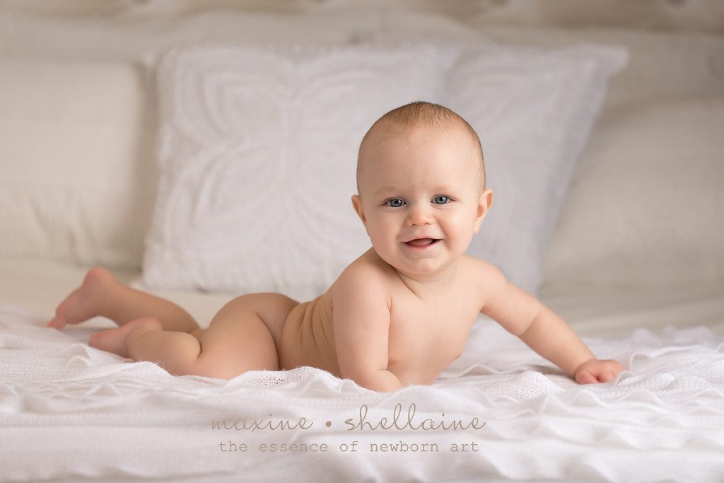 alt=edmonton baby photographer, alt=baby on white, alt=baby on bed, alt=7 month baby picture, alt=7 month boy