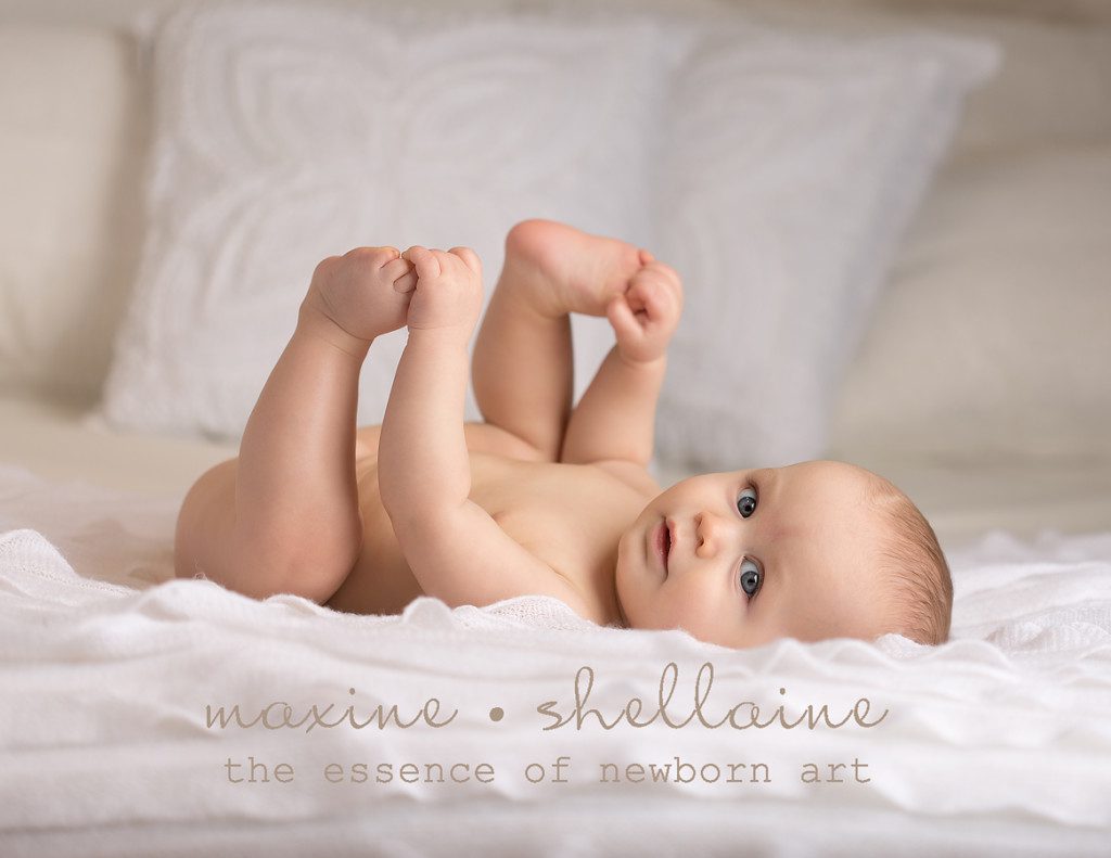alt=edmonton baby photographer, alt=baby on white, alt=baby on bed, alt=7 month baby picture, alt=7 month boy