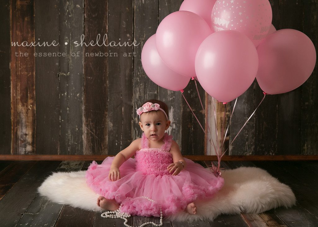 Alt=One Year Old Milestone, Alt=Pink dress and balloons, Alt=pearl necklace, Alt=pink headband, Alt=cute one year old photography set