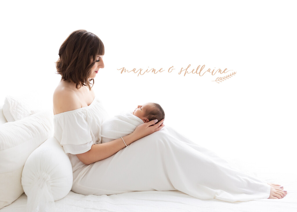 alt=high key image of mom and baby, alt=mom with newborn on white background