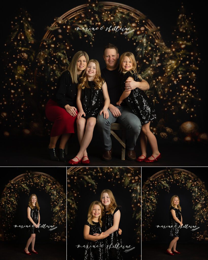 alt=Family of four posing closely together, dressed in festive black and red outfits, seated in front of a large illuminated evergreen arch on a dark holiday backdrop, alt=Christmas Mini Sessions 2025 – Edmonton | Maxine & Shellaine Photography
